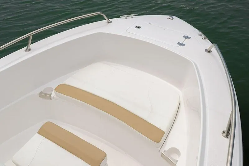 Slide: The Image of 2026 Edgewater 188CC boat with dual outboard motors, docked on a concrete surface. - 1