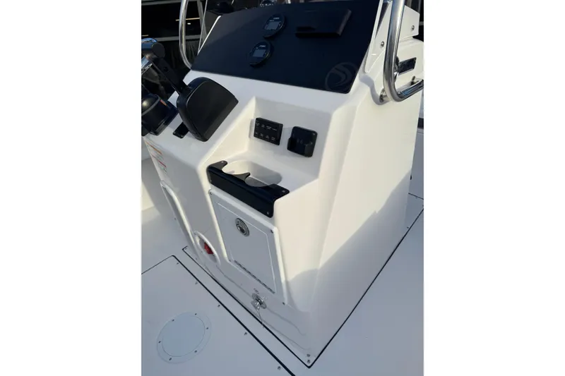 Slide: The Image of 2026 Edgewater 188CC boat console with controls and storage compartment. - 10
