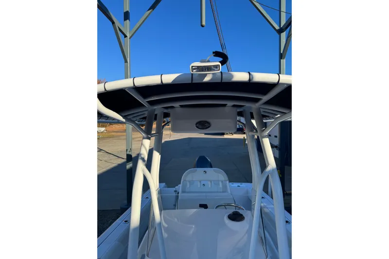 Slide: The Image of 2026 Edgewater 208CC boat with T-top and clear blue sky background. - 11