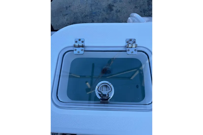 Slide: The Image of Livewell on 2026 Edgewater 208CC boat, featuring a transparent lid and secure latch. - 13