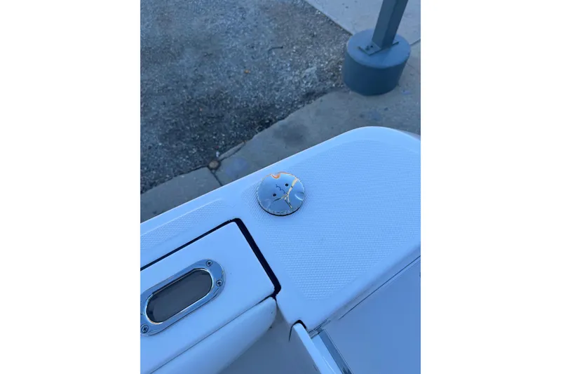 Slide: The Image of 2026 Edgewater 208CC boat detail, featuring a sleek white surface and metal fittings. - 15