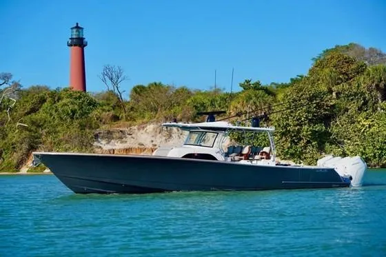 The Image of 2021 Valhalla Boatworks V-46 cruising near a lighthouse on a sunny day. - 1