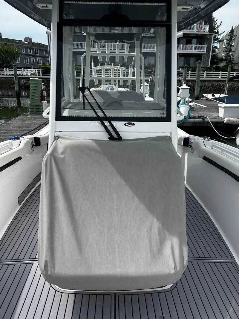 Slide: The Image of 2024 Tidewater 280 CC Adventure boat docked, featuring sleek design and covered console. - 10