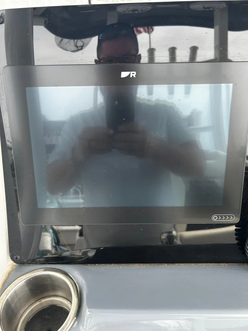 Slide: The Image of 2024 Tidewater 280 CC Adventure boat dashboard with touchscreen display. - 12