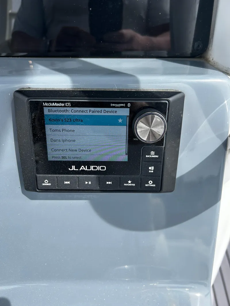 Slide: The Image of JL Audio system on 2024 Tidewater 280 CC Adventure boat dashboard. - 14