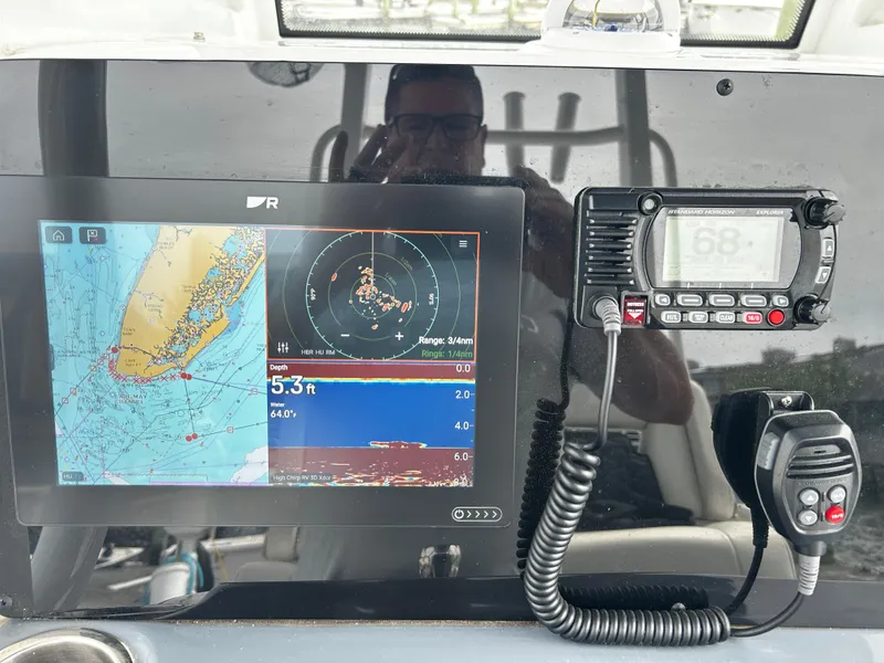Slide: The Image of Dashboard of 2024 Tidewater 280 CC Adventure with navigation and communication equipment. - 18