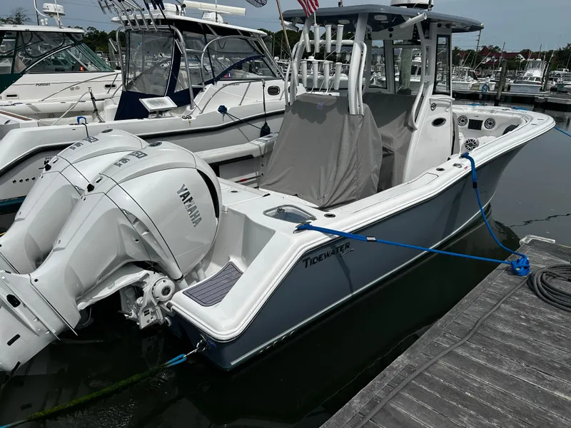 Slide: The Image of 2024 Tidewater 280 CC Adventure boat docked with Yamaha outboard engine. - 2