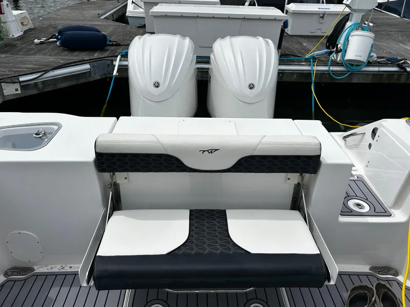 Slide: The Image of 2024 Tidewater 280 CC Adventure boat with dual engines at a dock. - 28
