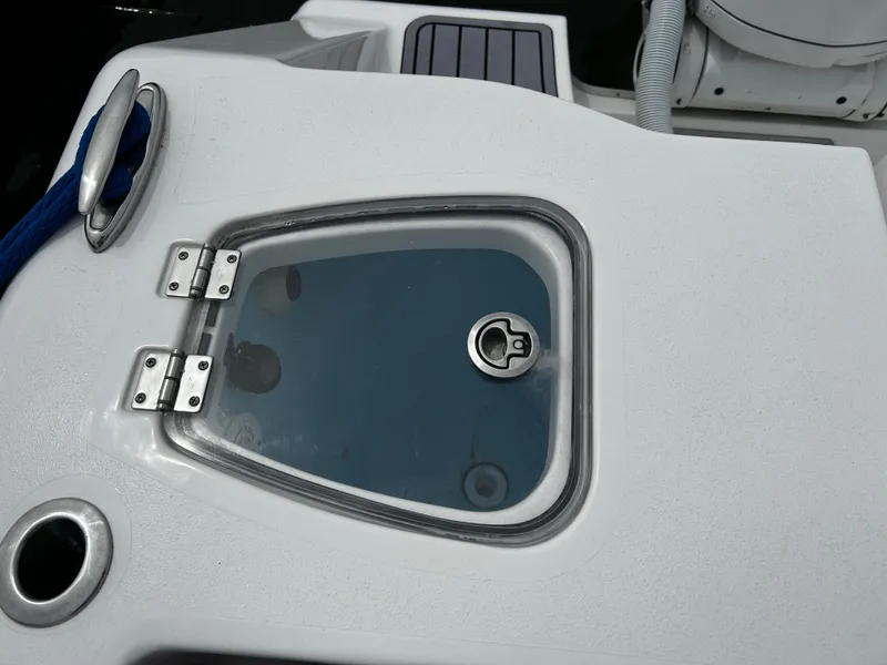 Slide: The Image of 2024 Tidewater 280 CC Adventure boat hatch with stainless steel hinges and handle. - 30