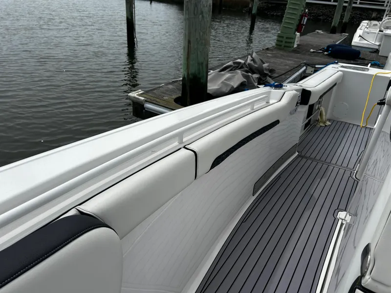 Slide: The Image of 2024 Tidewater 280 CC Adventure boat with sleek seating and dockside view. - 32