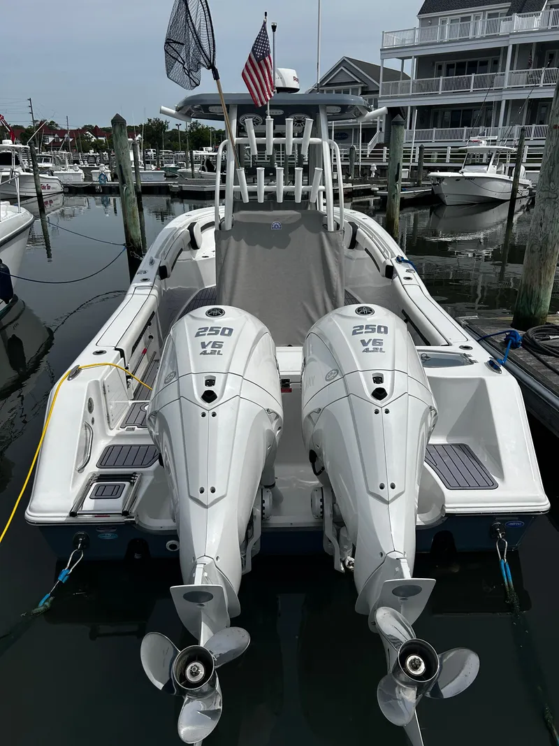 Slide: The Image of 2024 Tidewater 280 CC Adventure boat docked with twin 250 HP engines. - 4