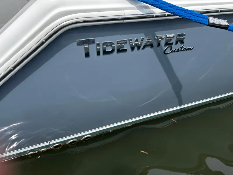 Slide: The Image of 2024 Tidewater 280 CC Adventure boat with blue hull and custom lettering. - 5