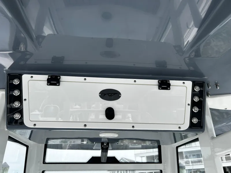 Slide: The Image of 2024 Tidewater 280 CC Adventure boat console with storage compartment and sleek design. - 6