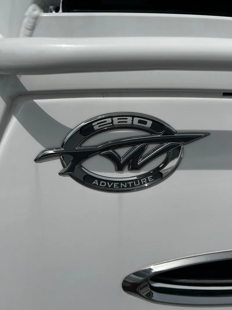 Slide: The Image of 2024 Tidewater 280 CC Adventure boat emblem on white surface. - 7
