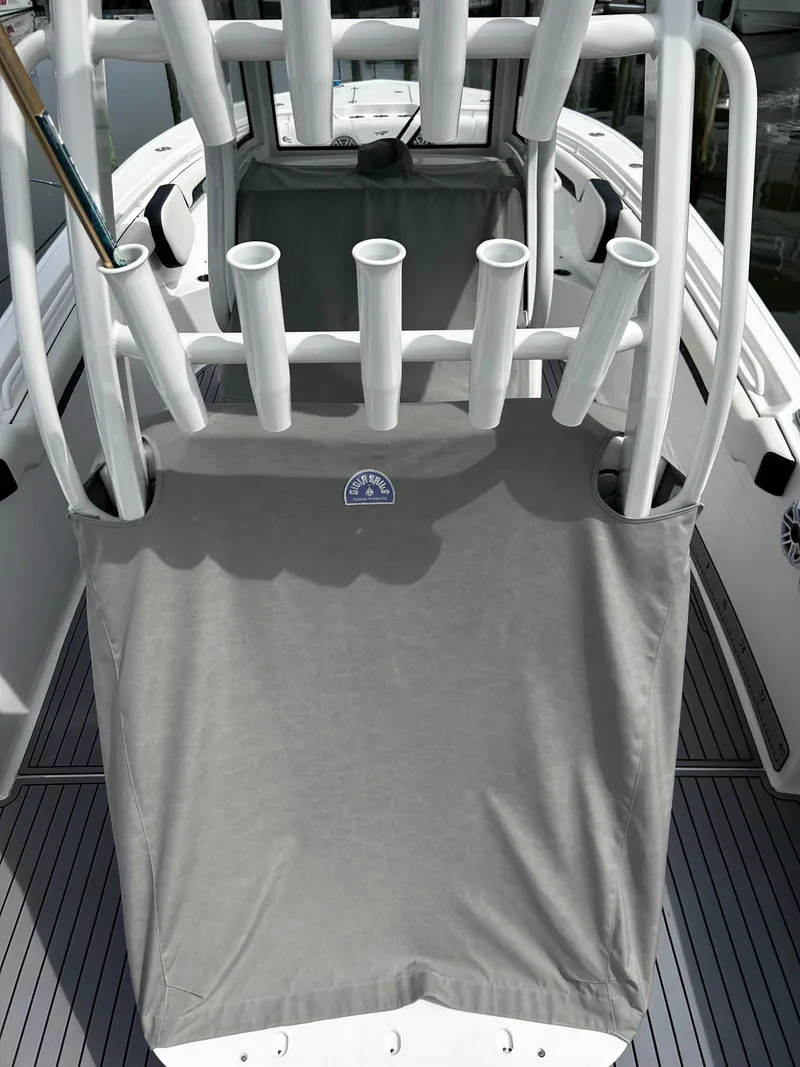 Slide: The Image of 2024 Tidewater 280 CC Adventure boat with rod holders and protective cover. - 8