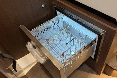 Slide: The Image of 2025 Beneteau Antares 11 Fly yacht interior with open drawer-style refrigerator. - 12