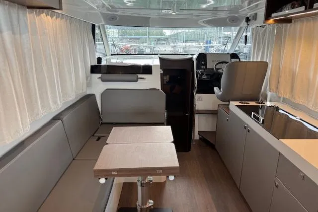 Slide: The Image of Interior of 2025 Beneteau Antares 11 Fly, featuring modern seating and helm station. - 5