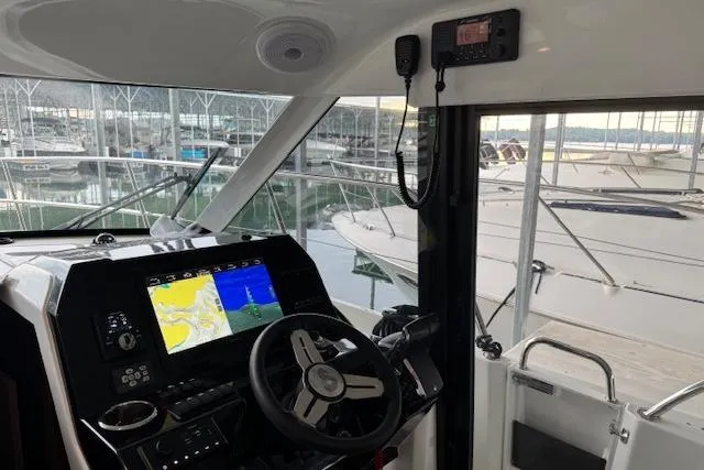 Slide: The Image of Interior view of 2025 Beneteau Antares 11 Fly boat cockpit with navigation system. - 8