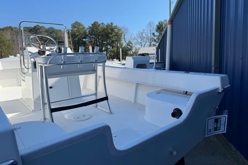 Slide: The Image of 2026 C-Hawk 200 Center Console boat with sleek design, parked outdoors. - 11