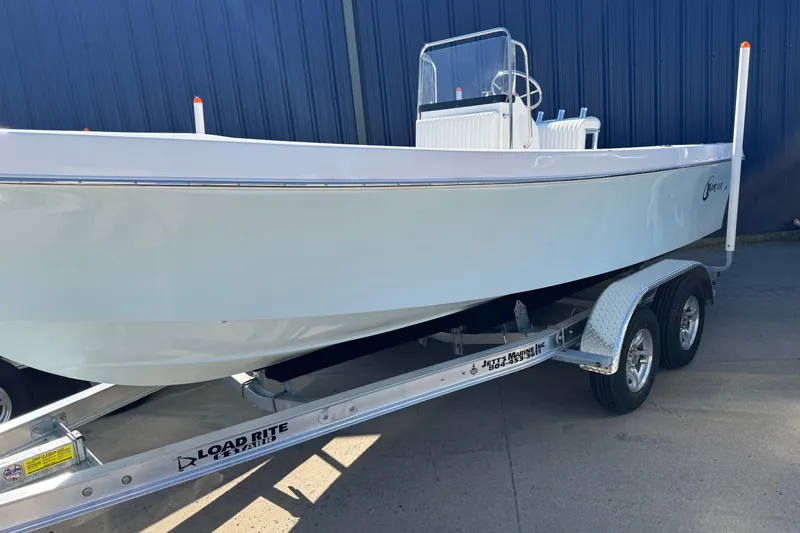 Slide: The Image of 2026 C-Hawk 200 Center Console boat on Load Rite trailer, parked outdoors. - 12