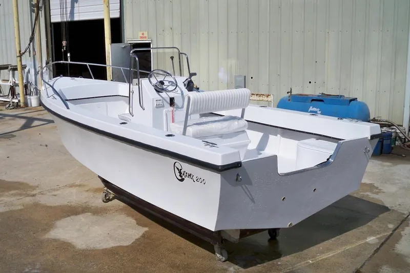 Slide: The Image of 2026 C-Hawk 200 Center Console boat with frosted seating and railing. - 2