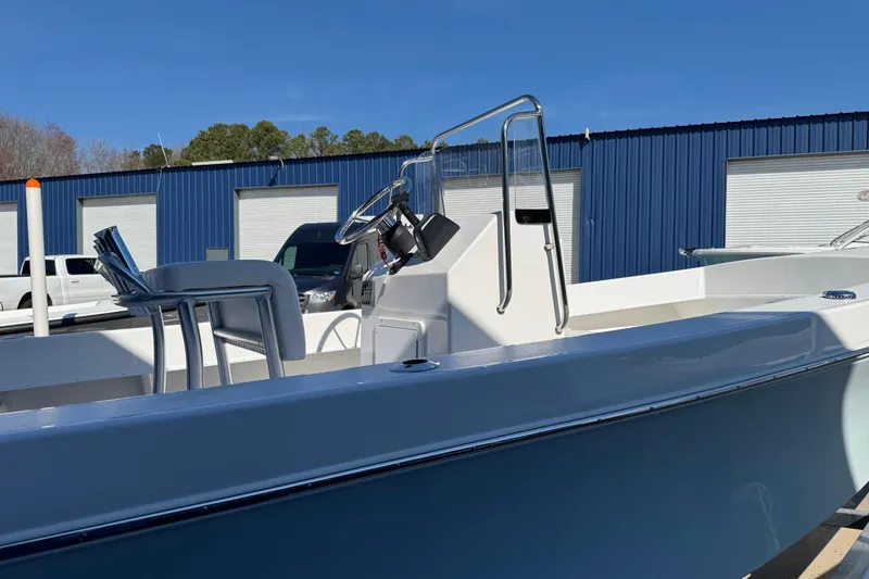 Slide: The Image of 2026 C-Hawk 200 Center Console boat with sleek design, parked outdoors. - 7