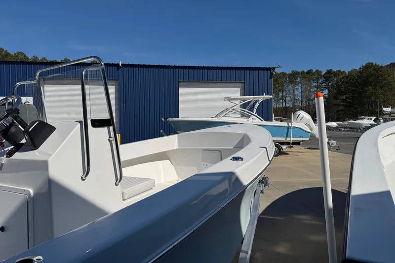 Slide: The Image of 2026 C-Hawk 200 Center Console boat displayed outdoors near blue building. - 8