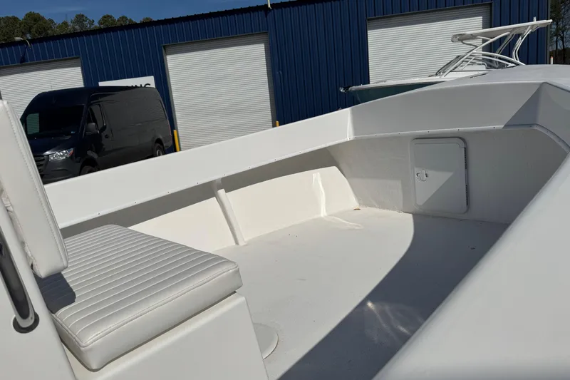 Slide: The Image of 2026 C-Hawk 200 Center Console boat interior with white seating and storage compartment. - 9