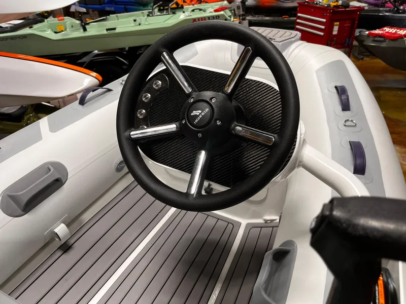 Slide: The Image of 2025 Highfield Classic 310 FCT boat steering wheel, featuring sleek design and modern controls. - 14