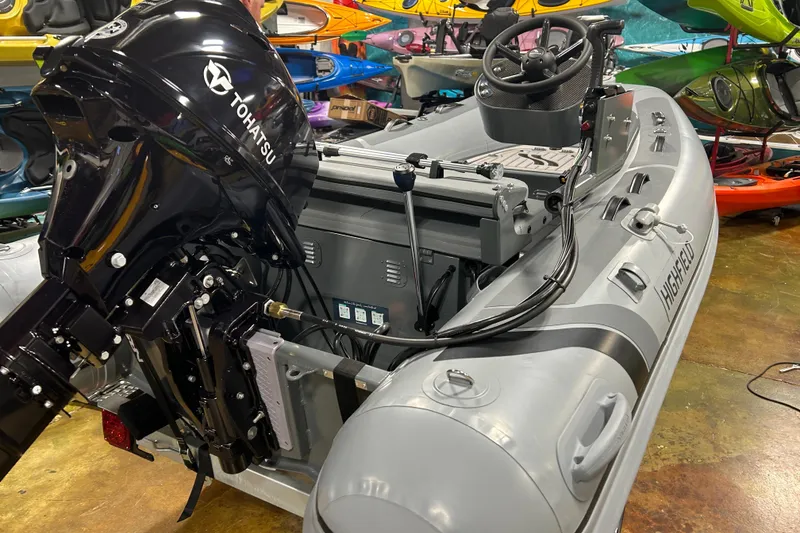 Slide: The Image of 2025 Highfield Classic 310 FCT inflatable boat with Tohatsu outboard motor in showroom. - 3