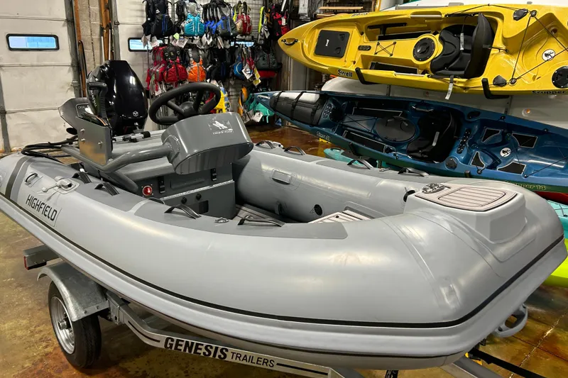 Slide: The Image of 2025 Highfield Classic 310 FCT inflatable boat on Genesis trailer in showroom. - 4