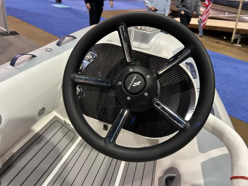Slide: The Image of Steering wheel of 2025 Highfield Classic 310 FCT boat at a marine exhibition. - 7