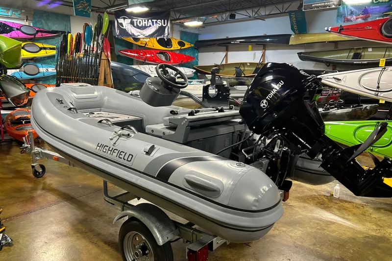 Slide: The Image of 2025 Highfield Classic 310 FCT boat with Tohatsu engine in showroom. - 1