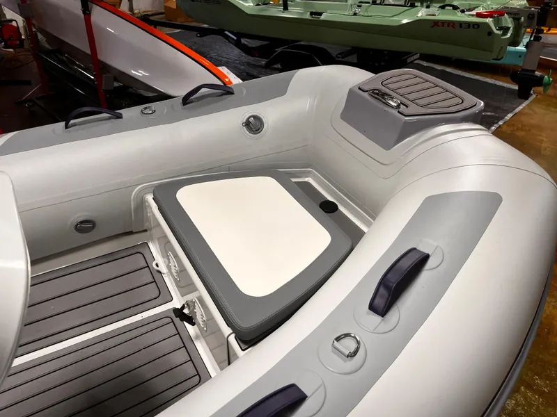 Slide: The Image of 2025 Highfield Classic 310 FCT inflatable boat interior with seating and storage. - 13