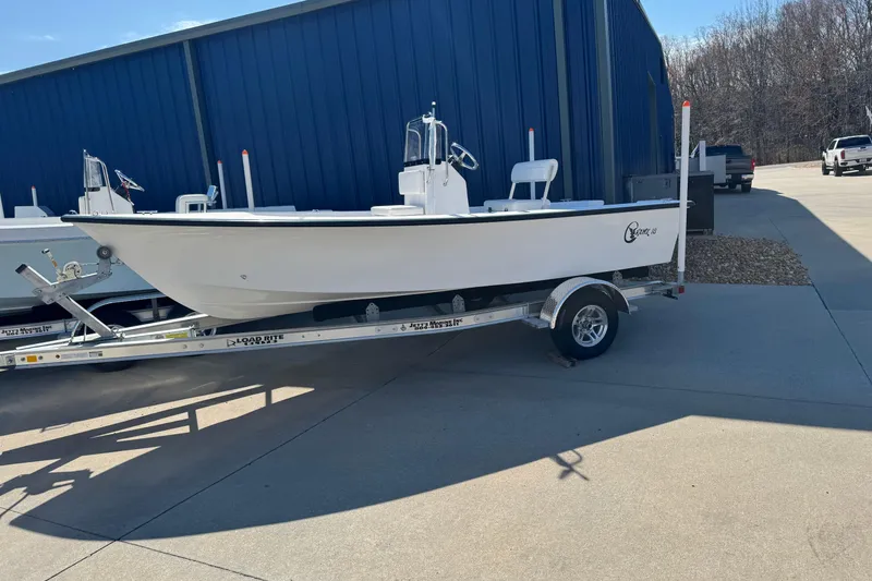 Slide: The Image of 2026 C-Hawk 18 Center Console boat on trailer, parked near blue building. - 10