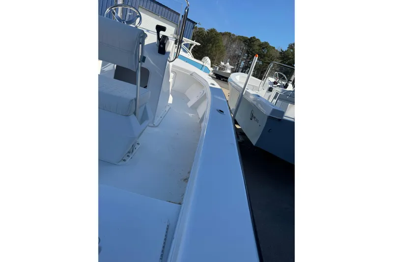 Slide: The Image of 2026 C-Hawk 18 Center Console boat, white interior, parked outdoors. - 15