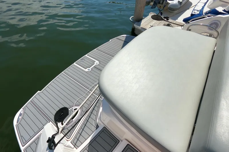 Slide: The Image of 2011 Regal 42 Sport Coupe boat deck with seating and dock view. - 3