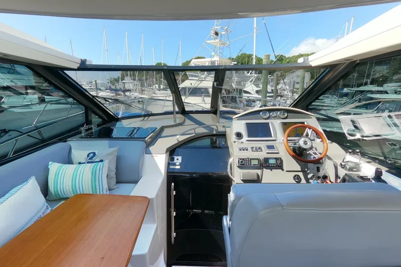 Slide: The Image of Interior view of 2011 Regal 42 Sport Coupe yacht with helm and seating area. - 4