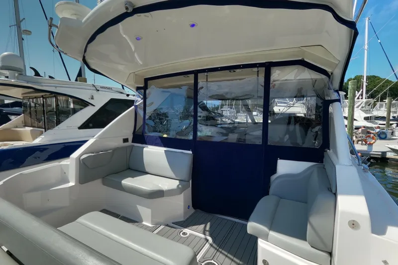 Slide: The Image of 2011 Regal 42 Sport Coupe yacht interior with seating, docked at marina. - 5