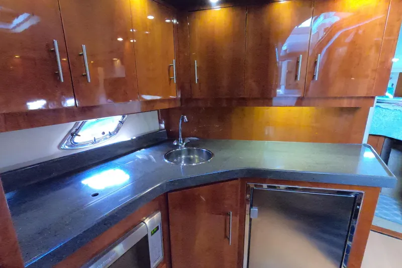 Slide: The Image of Luxurious kitchen interior of 2011 Regal 42 Sport Coupe yacht with sleek wood cabinetry. - 6