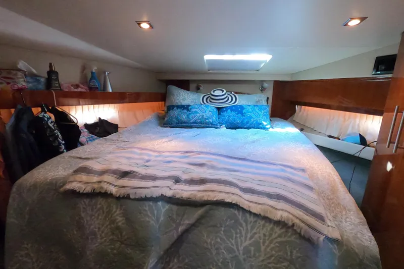Slide: The Image of Cozy cabin interior of 2011 Regal 42 Sport Coupe with bed and ambient lighting. - 7