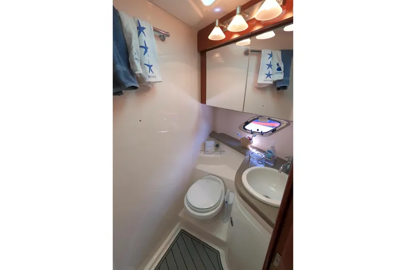 Slide: The Image of Bathroom interior of 2011 Regal 42 Sport Coupe yacht, featuring sink and toilet. - 9