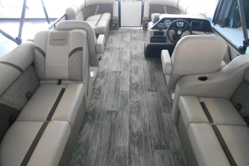 Slide: The Image of 2025 Crest Classic LX 200 SLC pontoon boat interior with luxurious seating and modern dashboard. - 10