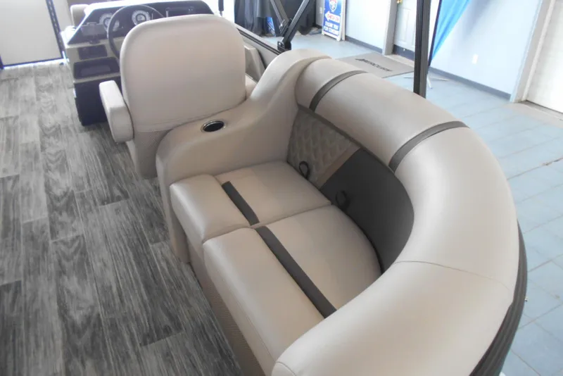 Slide: The Image of 2025 Crest Classic LX 200 SLC boat interior with beige seating and wood-style flooring. - 12