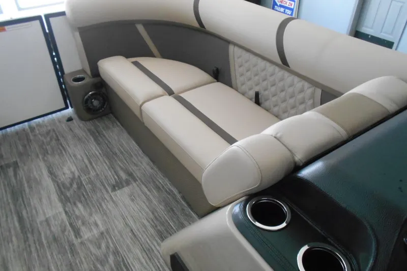 Slide: The Image of 2025 Crest Classic LX 200 SLC interior with beige seating and cup holders. - 15