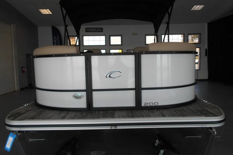 Slide: The Image of 2025 Crest Classic LX 200 SLC pontoon boat in showroom, rear view. - 3