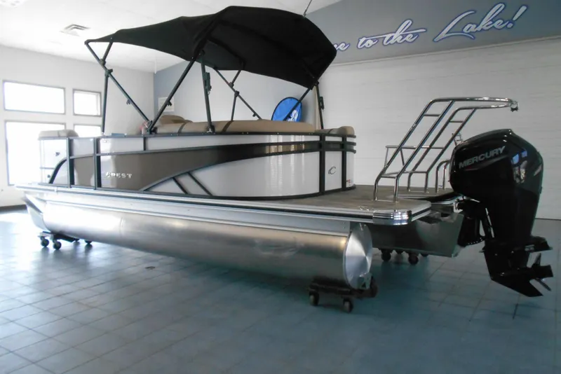 Slide: The Image of 2025 Crest Classic LX 200 SLC pontoon boat with Mercury outboard motor in showroom. - 4