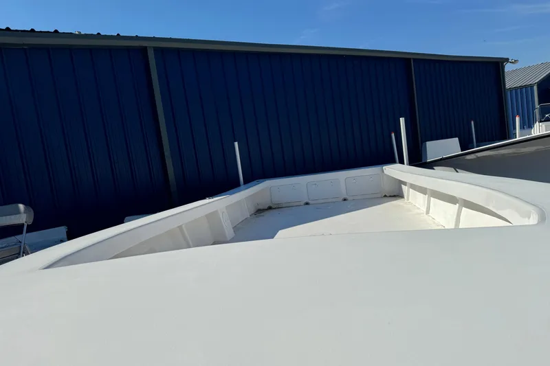 Slide: The Image of 2026 C-Hawk 25 Center Console boat deck near blue warehouse. - 11