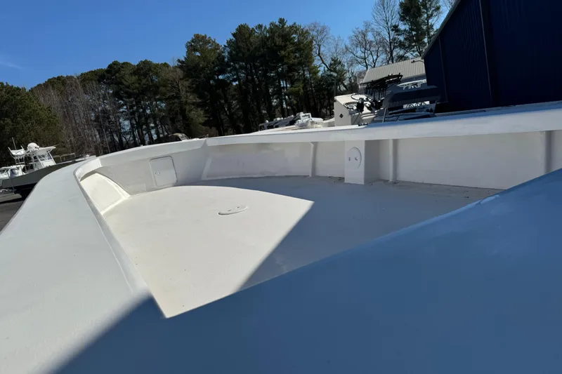 Slide: The Image of 2026 C-Hawk 25 Center Console boat deck, surrounded by trees and blue sky. - 13