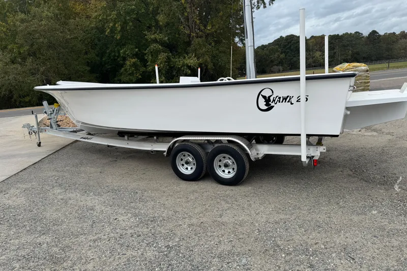 The Image of 2026 C-Hawk 26 Center Console boat on trailer, parked outdoors. - 2